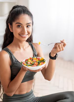 sporty-young-indian-woman-eating-fresh-salad-after-workout_116547-78097 sporty-young-indian-woman-eating-fresh-salad-after-workout_116547-78097